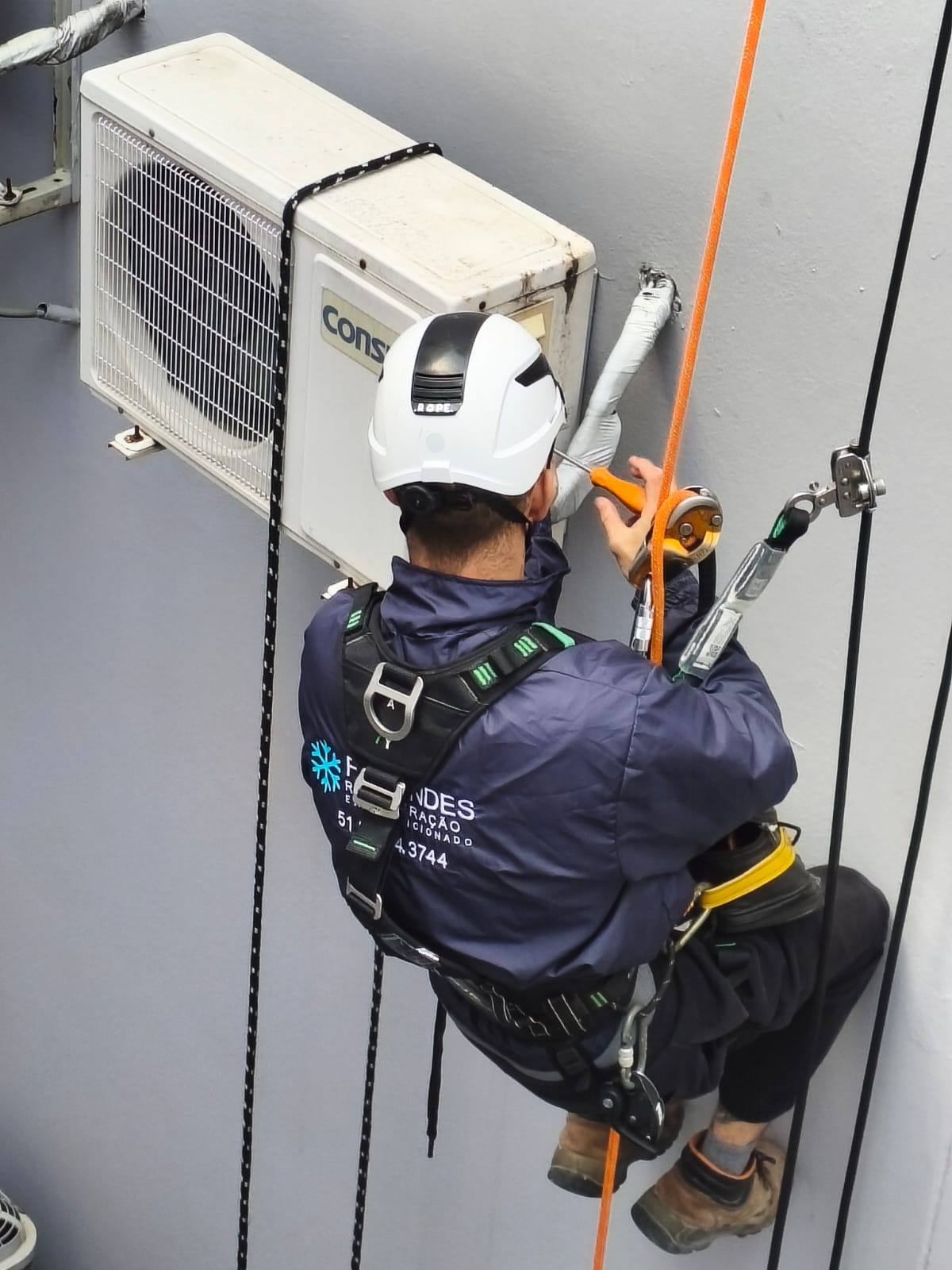 Técnico da Fagundes Refrigeração realizando serviço em altura com acesso por rapel